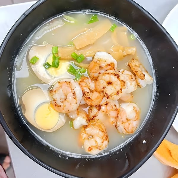 Asian Arch shrimp noodle soup with bamboo shoots, green onions, and hard-boiled eggs.